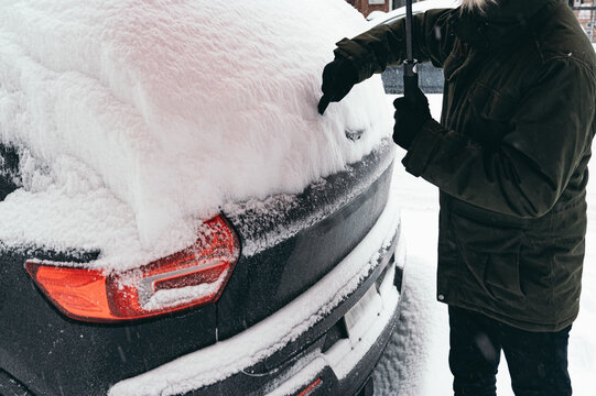 Winter snow removal from a car in Brooklyn, USA