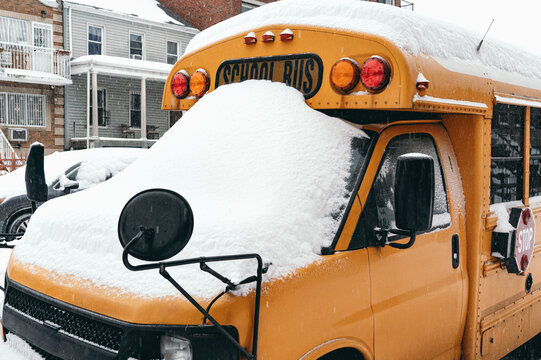 Yellow school bus covered in snow in Brooklyn