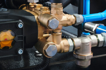 Fototapeta premium Industrial machine concept, industrial hydraulic machine with rubber and metal pipes high pressure pipes, real technical image.