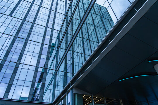 Modern glass office building with blue facade