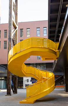 Yellow spiral staircase in an industrial setting