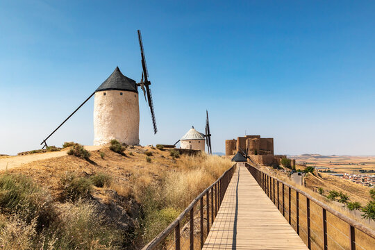 Iconic windmills of La Mancha under a clear blue sky