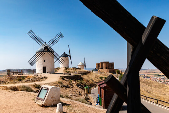 Historic windmills in La Mancha under blue sky