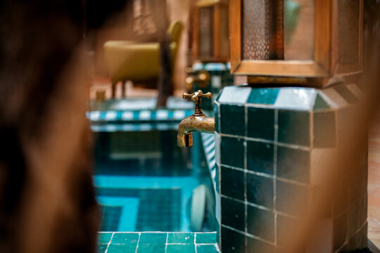 Gold water tap with Moroccan decor in Marrakech