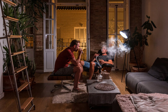 Men relaxing in evening at home