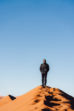 Traveler at the summit of Dune 45 in Namibia
