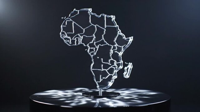 Glass sculpture of the African continent with borders on a reflective platform with elegant lighting