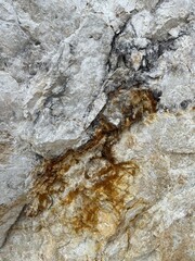 Obraz premium Natural stone texture with white marble surface and golden brown quartz veins, abstract mineral background