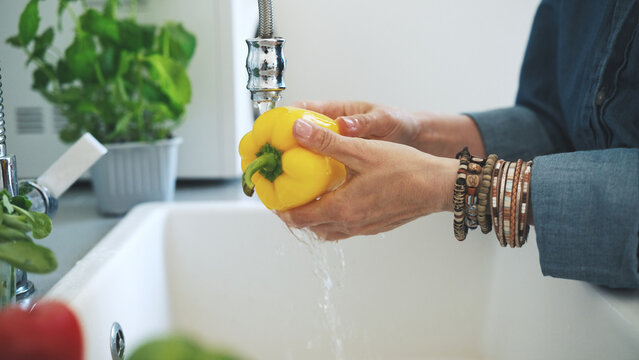 Woman Washing Yellow Pepper