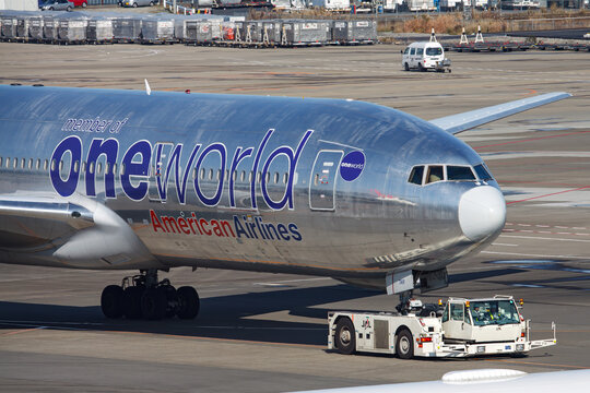 Narita, Chiba Japan - Dec 9, 2010: An American Airlines Boeing 777-200ER aircraft in special oneworld alliance livery parked at the apron of Narita International Airport.