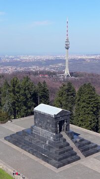 Aerial vertical orbit around Monument to the Unknown Hero with Avala tower