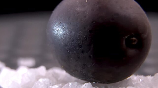 Dark Olives (Olea europaea) with coarse sea salt, moisture extraction during dry curing, Illustration of aggressive osmosis