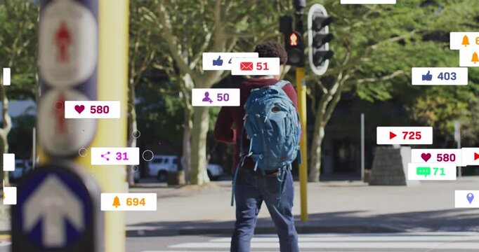 Animation of social media icons against rear view of african american man crossing the street