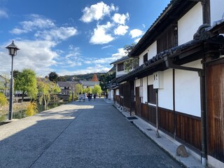 Kurashiki Bikan Historical Quarter with traditional white-walled buildings and willow trees along the canal, Okayama, Japan

