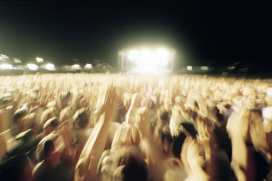 Music festival crowd in the early 2000s, disposable camera raised above heads, muddy field, stage lights in distance, film grain and motion blur.