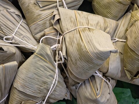 Traditional Chinese Zongzi or Ba-chang Steamed Sticky Rice Wrapped in Bamboo Leaves.