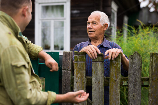 Senior man having conversation with his neighbour