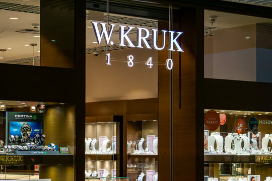 Elegant illuminated W.KRUK 1840 sign in shopping mall, luxury jewelry boutique with Certina watches and jewelry displays in glass showcases, modern interior of prestigious heritage store in retail gal