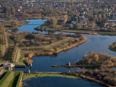 Aerial view of the winding water moats and historical defense lines surrounded by autumn greenery, Gdansk, Pomerania, Poland, Europe.