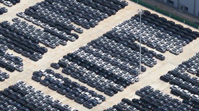 Aerial view of new cars parking in a lot awaiting export