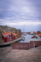 Fototapeta premium Traditional red fishing houses and harbor in Smögen Sweden