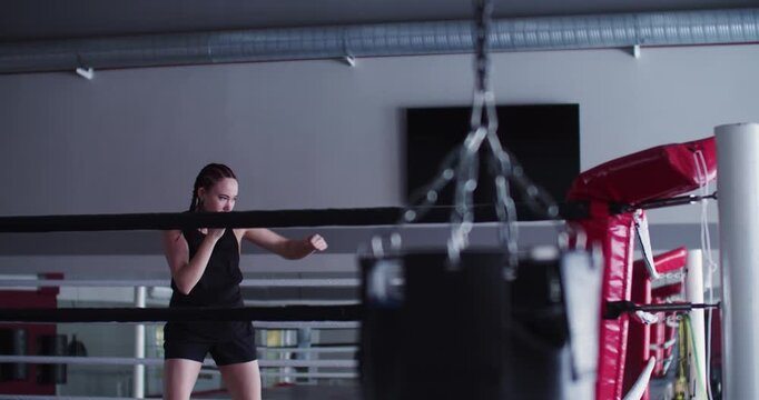 This video shows a female boxer's dedication to speed and form during shadow fighting, preparing her for fast-paced action in the ring.