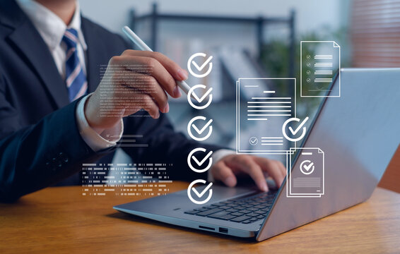 Businessman using laptop and digital pen to verify online documents with checklist interface, representing workflow management, document approval, electronic signature and business compliance concept.