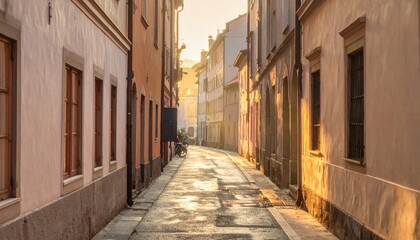 Obraz premium A sunlit European street framed by old buildings, perspective leading toward light