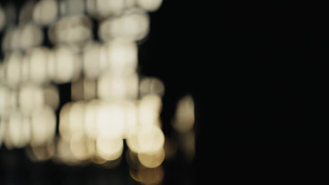 Silhouette of a hand opening with bokeh background