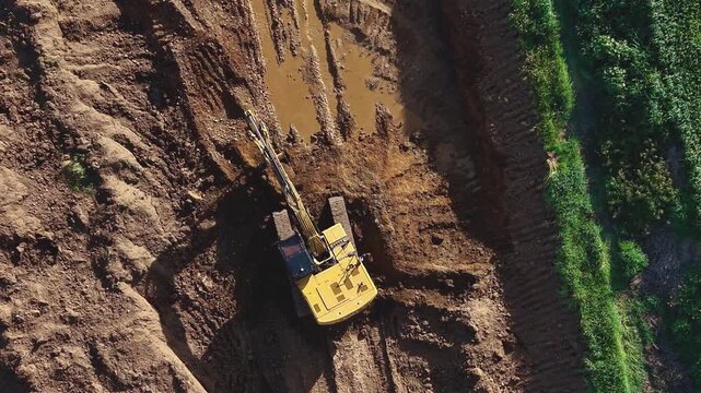 La excavadora levanta la arena: espera lista para cargar el dumper en la cantera