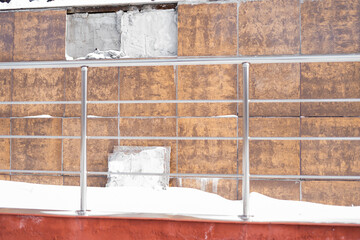 Tile fell off house in cold season and revealed damaged wall  