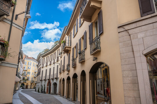 Milan, italy, april 1, 2024. Via della madonnina in milan&rsquo;s brera: narrow cobblestone street lined with historic facades, boutiques and blue summer sky above