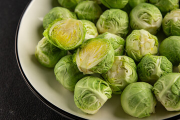 Fototapeta premium Brussels sprouts organic vegetable bio cooking tasty snack fresh gourmet food background on the table rustic food top view copy space vegetarian and vegan food marketing concept photo