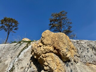 A low rocky hill and the sky on a sunny summer day.