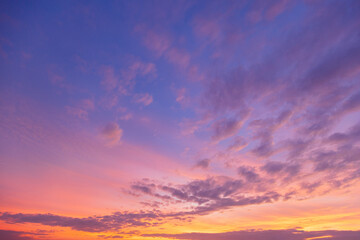 Fototapeta premium Breathtaking Vibrant Sunset Sky with Purple and Orange Pastel Clouds,A stunning twilight sky featuring a beautiful gradient of deep purple, soft pink, and vibrant orange. The scattered altocumulus.