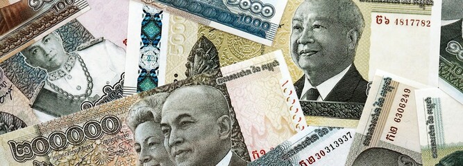 Cambodian riel money bills pile on table. Cambodia banknotes of KHR currency close up. Concept of business, economy and banking in Cambodia © mehaniq41