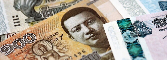 Cambodian riel money bills pile on table. Cambodia banknotes of KHR currency close up. Concept of business, economy and banking in Cambodia © mehaniq41