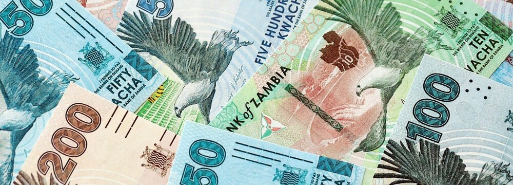 Zambian kwacha money bills pile on table. Zambia banknotes of ZMW currency close up. Concept of business, economy and banking in Zambia