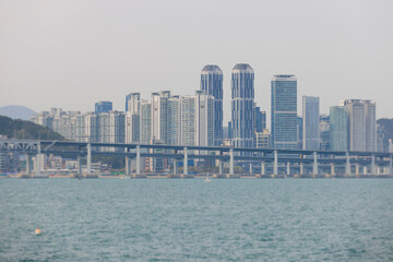 Obraz premium Busan Bay yacht boat cruise, Busan, South Korea, Yongho-dong, with Gwangan Diamond bridge, marina skyline and port harbor panorama, during boat excursion tour, Korean Strait, Haeundae river cruise