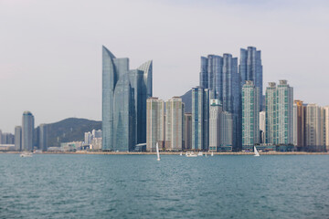 Fototapeta premium Busan Bay yacht boat cruise, Busan, South Korea, Yongho-dong, with Gwangan Diamond bridge, marina skyline and port harbor panorama, during boat excursion tour, Korean Strait, Haeundae river cruise