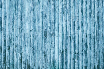 Weathered blue corrugated metal texture with vertical lines and industrial pattern