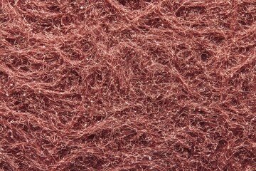 Fototapeta premium A close-up view of textured, fibrous material. The surface appears to be a network of intertwined strands, creating a unique visual pattern