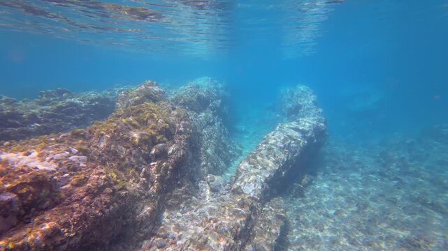 Sunlight refracting through clear turquoise water onto a rocky volcanic reef on Pr&iacute;ncipe Island, S&atilde;o Tom&eacute; and Pr&iacute;ncipe.