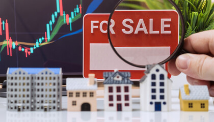 Real Estate Market Review with Houses, Magnifying Glass and Chart