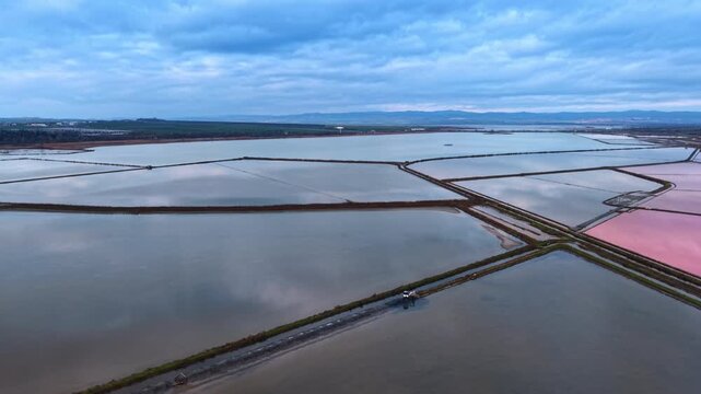 Differently-shaped salterns for salt crystallization. Natural resources usage for salt production. Aerial view.