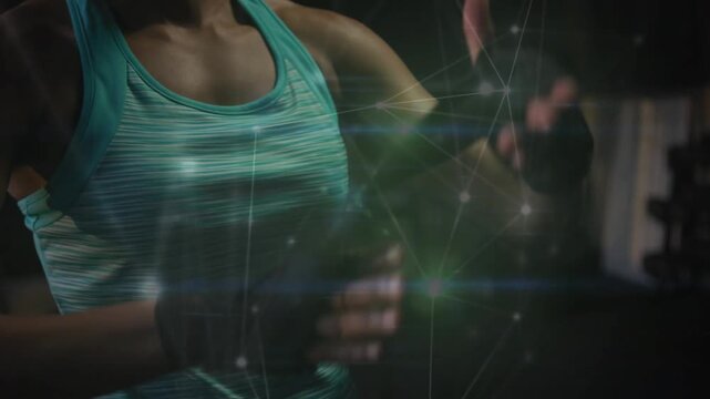 Female athlete reaching for wraps winding and tying for fitness overlay on knuckles revealing face