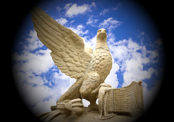Statue of an eagle with large wings close-up on a sky background. Symbol of freedom and liberty	
