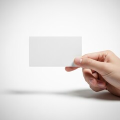 Obraz premium A hand holding a blank white business card