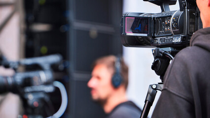 Cameraman filming video production with professional camera equipment on location