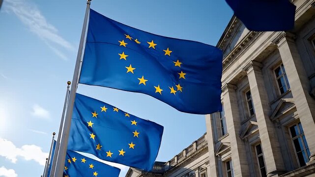 European Union Flags Waving Outside Government Building.